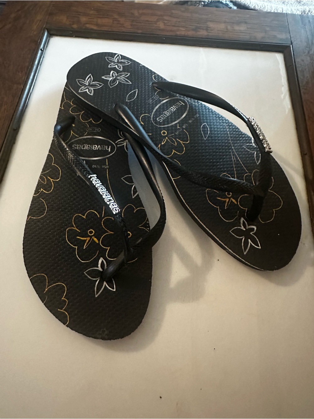Havaianas Black Flip Flop Sandals with Gold & White Floral Print